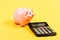 Piggy bank pig and calculator. Taxes and charges may vary. Accounting business. Taxes and fees concept. Tax savings