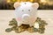 Piggy bank and pile many money coins on a wooden table. - Saving money concept, Save money with stack money coin for growing