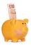 Piggy bank with plaster and ten pound note