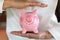 Piggy bank protected by hands, Savings protection, Financial hedging, Risk management