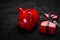 Piggy bank and red gift box with black ribbon on a black lace background