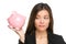 Piggy bank savings with unhappy funny woman