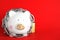 Piggy bank  with steel chain and padlock on red background. Money safety concept