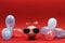 Piggy bank with sunglasses with USA flag and blue, red and white party balloons and two small USA flags on red background