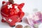 A piggy bank with Switzerland flag near banknotes on the white background