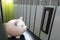 Piggy bank and thermometer on radiator. Saving heating in winter. Energy crisis, energy efficiency and rising heating costs in