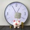 Piggy bank and tower coins on background of clock. The inscription Time is money. Copy space.