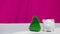 Piggy bank on white table little Christmas tree and pink background, saving money for spent on Christmas holiday with family and