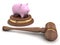 Piggy bank and a wooden legal auction gavel on white