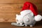 Piggy banks with Santa hat and dollar banknotes on table. Space for text