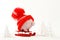 Piggy box with red hat with pompom standing on red sled on snow and around are snowbound trees - toboggan