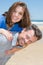 piggyback woman and man couple in love on sand beach vacation