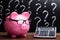 Piggybank With Eyeglasses And Calculator On Desk