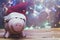 Piggybank with Santa Claus cap against decorated xmas tree. Christmas shopping. Saving money for Christmas. Pre-christmas spending