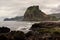 Piha black sand beach featuring cliffs and rock formations in New Zealand