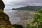 Piha black sand beach featuring cliffs and rock formations in New Zealand