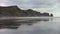 Piha black sand beach featuring cliffs and rock formations at in New Zealand