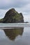 Piha black sand beach featuring cliffs and rock formations in New Zealand