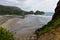 Piha black sand beach featuring cliffs and rock formations in New Zealand