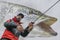 Pike fishing. Angler in action, fisherman catch muskie fish by spinning rod on blurred muskellunge background. Soft focus