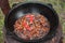 Pilaf prepare in big black cast iron with chefs hand.