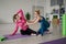 Pilates instructor and woman in sportswear in the gym corrects posture.Rehabilitation after injury.