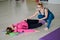 Pilates instructor and woman in sportswear in the gym corrects posture.Rehabilitation after injury.