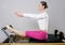 Pilates reformer woman gym fitness teacher legs