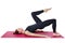 Pilates. Slender woman on the Mat performs the shoulder bridge exercise. Isolated on a white background