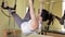 Pilates woman in cadillac split legs stretch exercise at gym