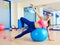 Pilates woman passes fitball exercise workout