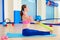 Pilates woman rowing rubber band exercise