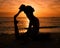 Pilates, yoga and silhouette of woman on beach at sunrise for exercise, training and fitness workout. Motivation