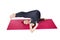 Pilates or yoga. A slender athletic girl is lying on the mat with her legs raised upside down.