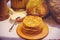 Pile of air pancakes on a wooden dinette, a traditional food family. pancakes of golden color, sour cream in the background