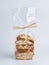 Pile of almond nuts Biscotti Cantucci Biscuits Cookies in plastic wrap packaging for sale. Italian dessert cookies close up,