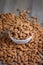 Pile of almonds nut in a while bowl against wooden background select focus shallow depth of field