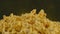 Pile of appetizing popcorn with dissipating steam. Unrecognizable person throws freshly cooked hot popcorn. Close up