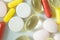 Pile of assorted medicine pills and capsules, macro pharmaceutical background. Top view.