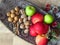 A pile of autumn fruit top view on brass bowl background. Green red apples, walnuts and a bunch of cinnamon . Rustic style photo.