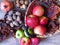 A pile of autumn fruit top view. Green red apples and walnuts in wicker baskets. Rustic style photo.