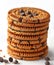 Pile of baked chocolate biscuits with choco chips on white background.AI generated