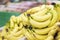 Pile of bananas in hypermarket against blurred shop shelves