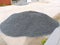 A pile of black and gray crushed stone at a construction site. Crushed stone for pouring the floor