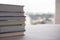 Pile of books over wood table with cityscape cloudy background