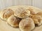 The pile of breads in the wooden dish.