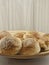 The pile of breads in the wooden dish.