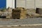 A pile of brown pieces of insulation stands on gray rubble