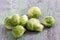 A pile of Brussels sprouts on old cracked paint wooden board background