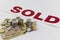 Pile of Canadian money with sold sign